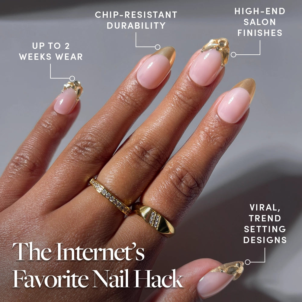 A hand with long, almond-shaped press-on nails from glamnetic’s Citrine set, showcasing gold foil French tips and clear designs. These viral trendsetting nails promise chip-resistant durability, a salon-quality finish, and up to 2 weeks of wear. The text reads: The Internet’s Favorite Nail Hack. - Product image