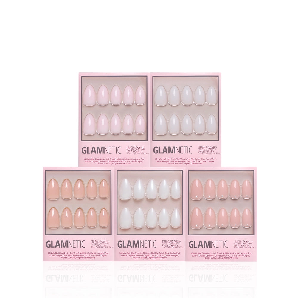 Five boxes of glamnetic’s Clean Girl Almonds short almond press-on nails are displayed in two rows against a white background. Each box features a selection of nude, light pink, and milky shades with ten neatly arranged nails per package, making it easy to achieve a salon-quality manicure at home. - Product image