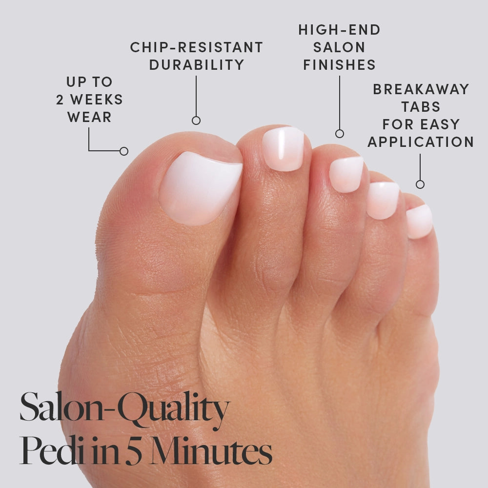 Close-up of white glossy Glamnetic press-on toenails, worn barefoot beside a pool in bright pink bow sandals and a gold toe ring. - Product image