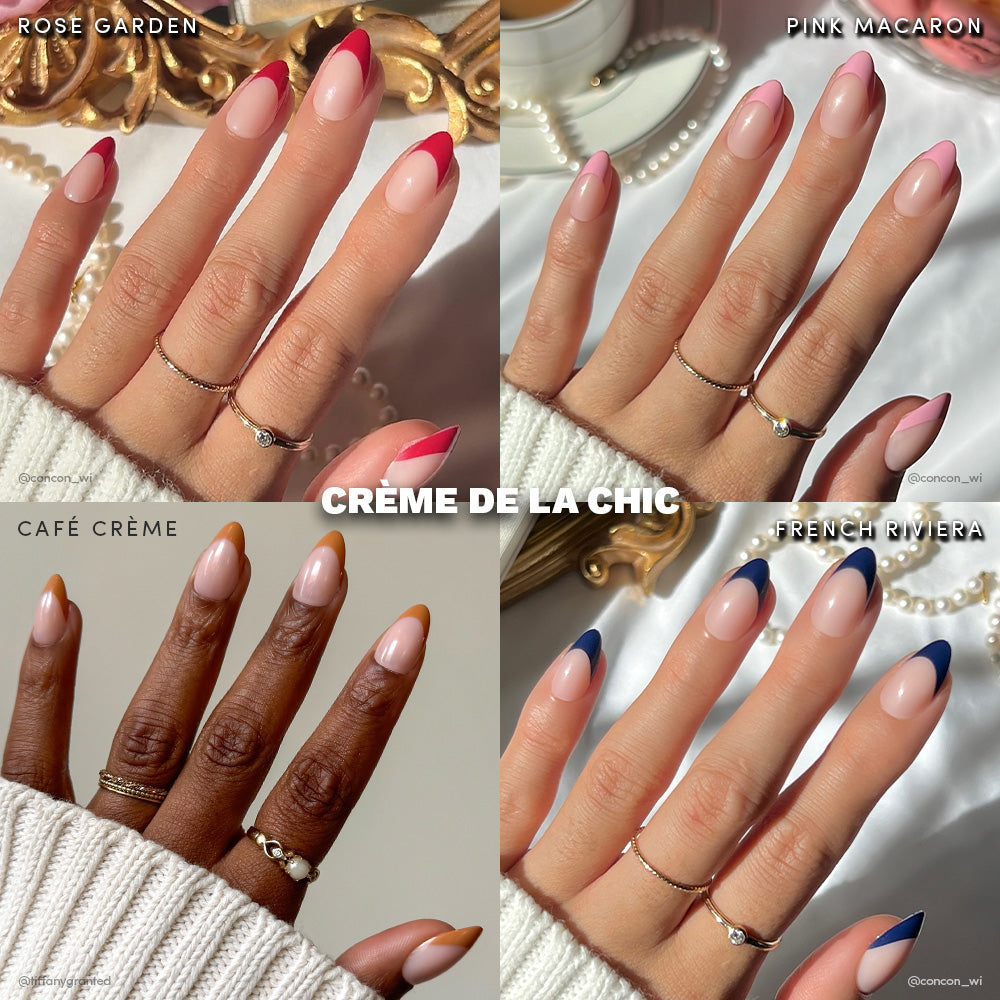 Four manicured hands with short almond nails, each featuring a unique French tip in rose pink, hot pink, mustard, and navy blue. Each is labeled and styled with minimalist rings. Text: glamnetic Crème de la Chic. Vegan & cruelty-free.