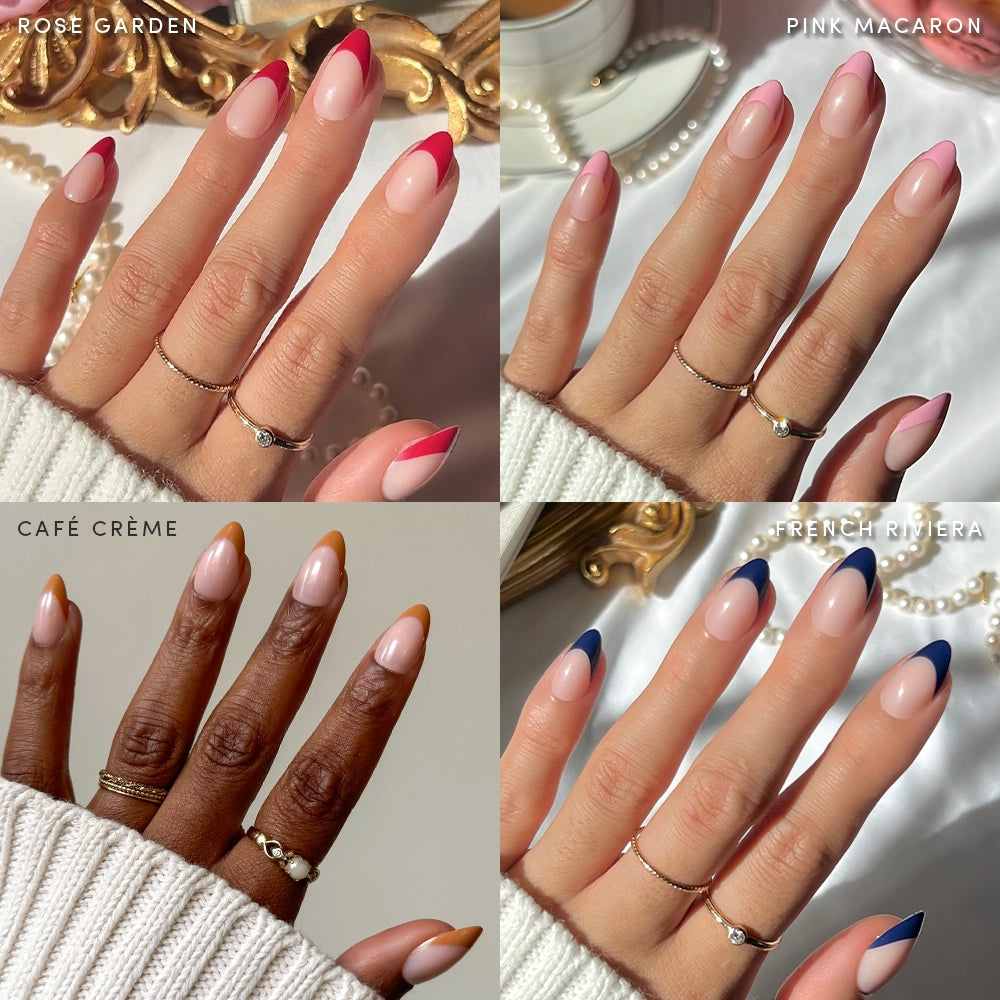 A collage shows four hands with short almond French tips in Crème de la Chic shades—Rose Garden (red), Pink Macaron (pink), Café Crème (brown), and French Riviera (navy)—by glamnetic. Each hand is adorned with rings.