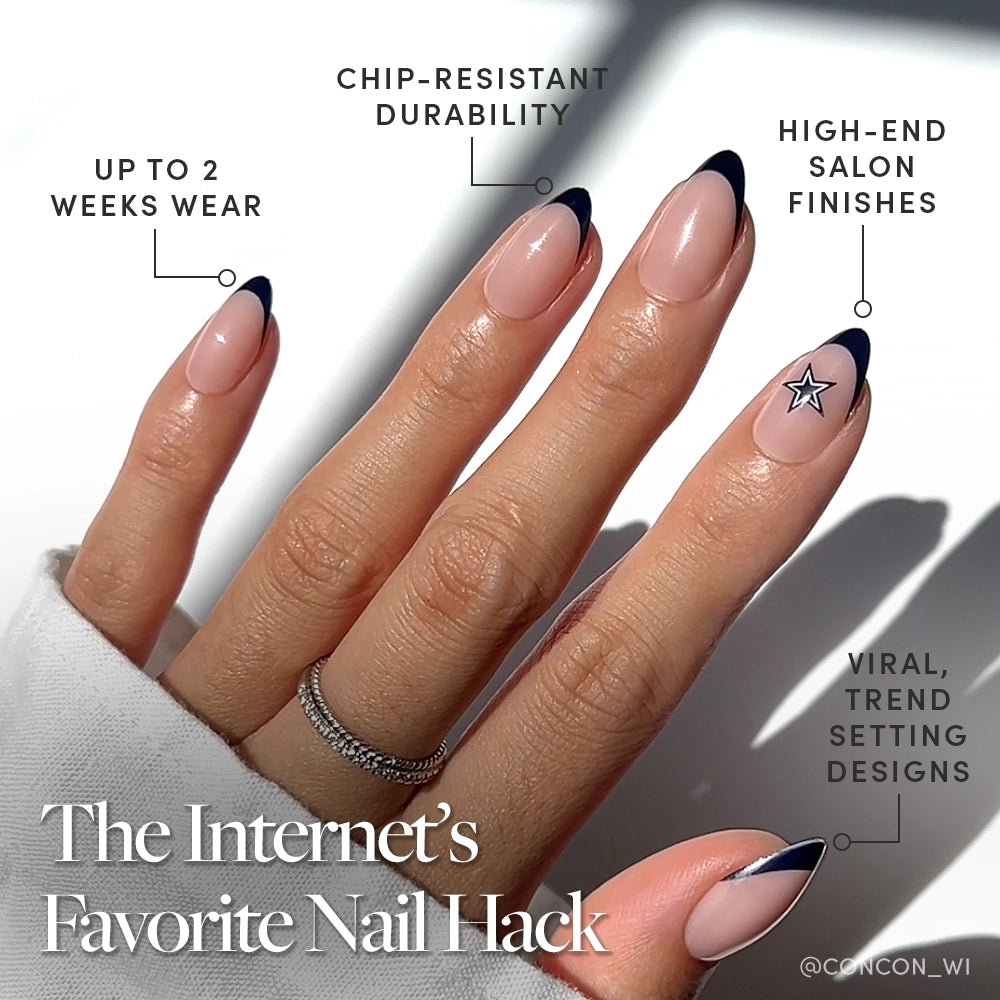 A hand with almond-shaped nails features a nude base and Cowboys blue French tips, plus a silver star accent. glamnetic’s Dallas Cowboys Press-On Nail Set offers chip resistance, long wear, salon finish, and a trendy team design. - Product image