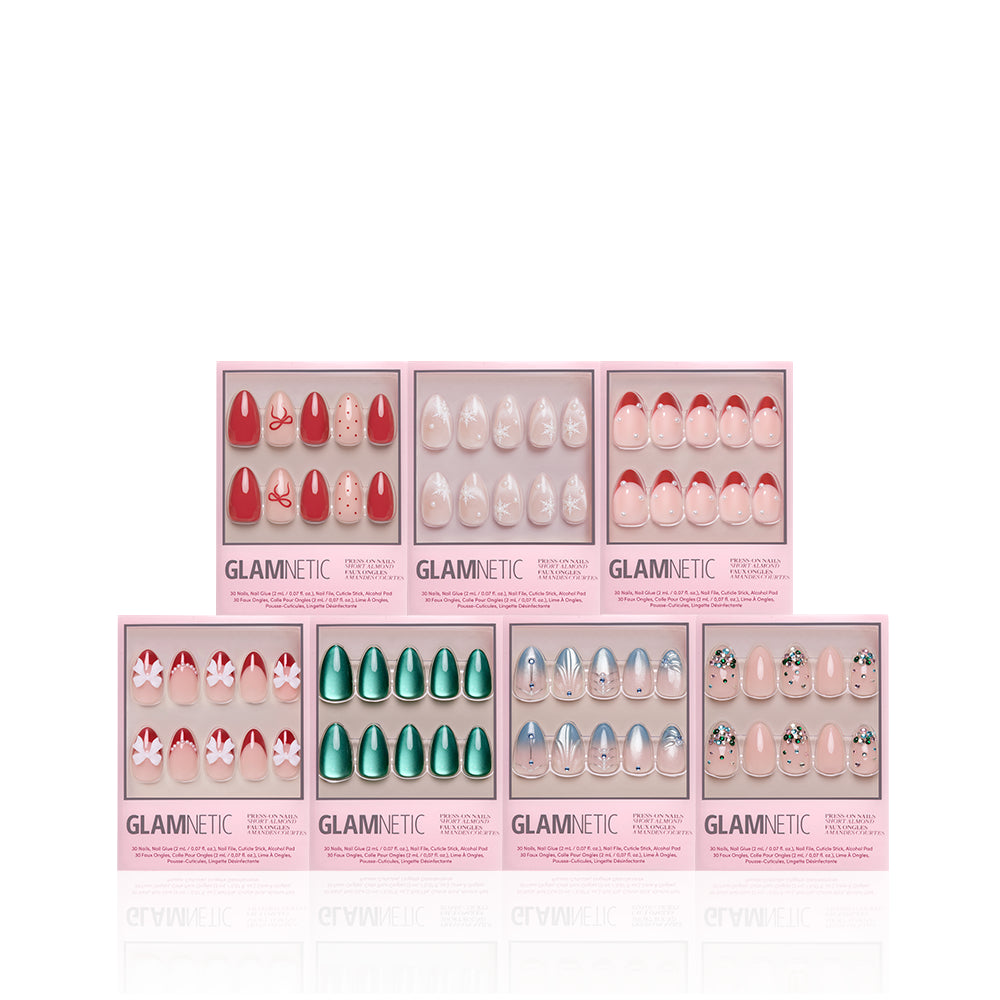 Decked Out Almonds - Seven sets of short almond Decked Out Almonds press-on nails in various colors and designs, displayed in individual retail boxes as part of a holiday nail bundle.