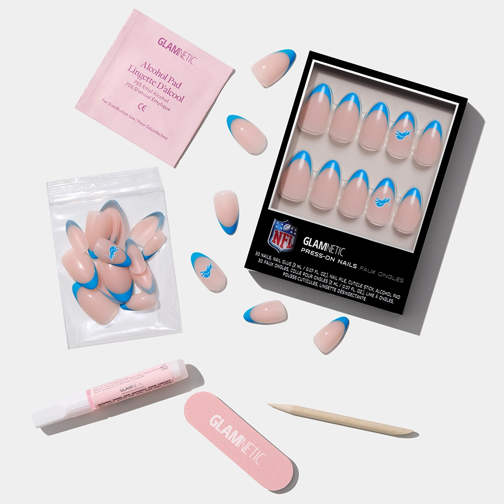 The glamnetic Detroit Lions Press-On Nail Set features blue-tipped, pink nails and includes glue, a nail file, wooden stick, alcohol pad, and extra nails—ideal for a football fan manicure. - Product image