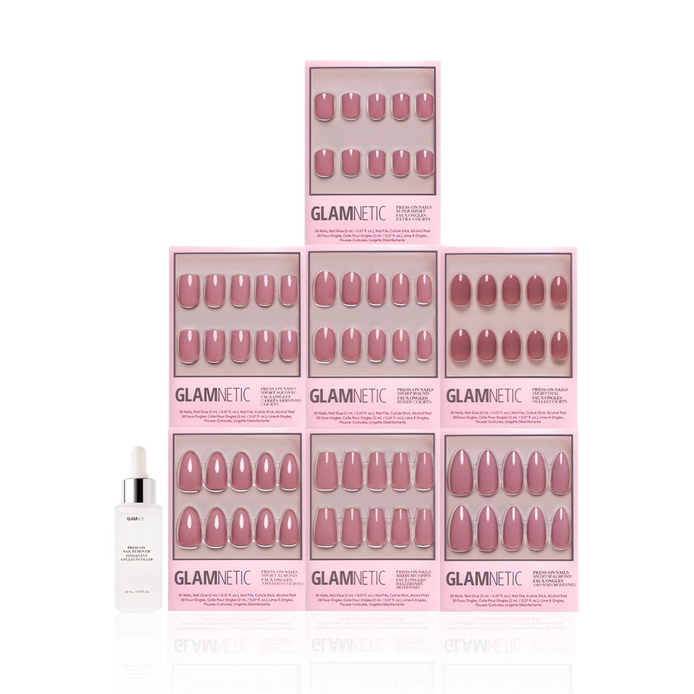 Nine boxes of the glamnetic Dreaming In Mauve Bundle are stacked in a pyramid, highlighting this nail set. A white dropper bottle sits in front of the boxes, all displayed on a white background. - Product image