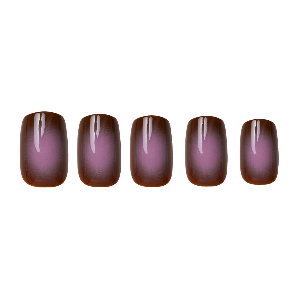 Five artificial nails from the glamnetic Eclipse set are displayed on a white background, each in a short squoval shape with a glossy gradient fading from earthy taupe brown at the edges to soft pinkish-purple at the center. - Product image