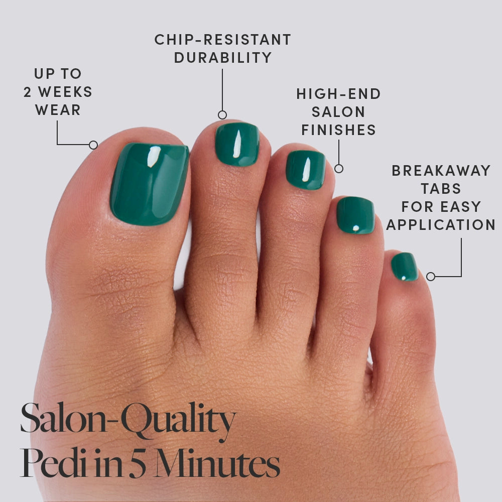 A close-up of a foot wearing glamnetic Emerald Green Toenail Press-Ons, highlighting chip-resistant strength, salon finish, up to 2 weeks wear, easy breakaway tabs. Text: Salon-Quality Pedi in 5 Minutes. - Product image