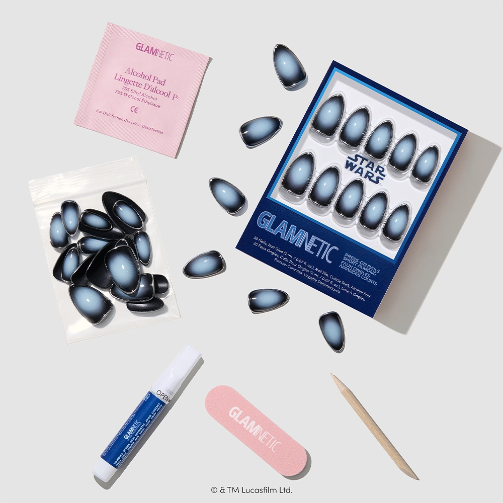Introducing Emperor by glamnetic: a STAR WARS press-on nail kit featuring blue ombre almond press-on nails. This cruelty-free set includes an alcohol pad, glue, nail file, wooden cuticle stick, and extra nails—all elegantly arranged on a light background. - Product image