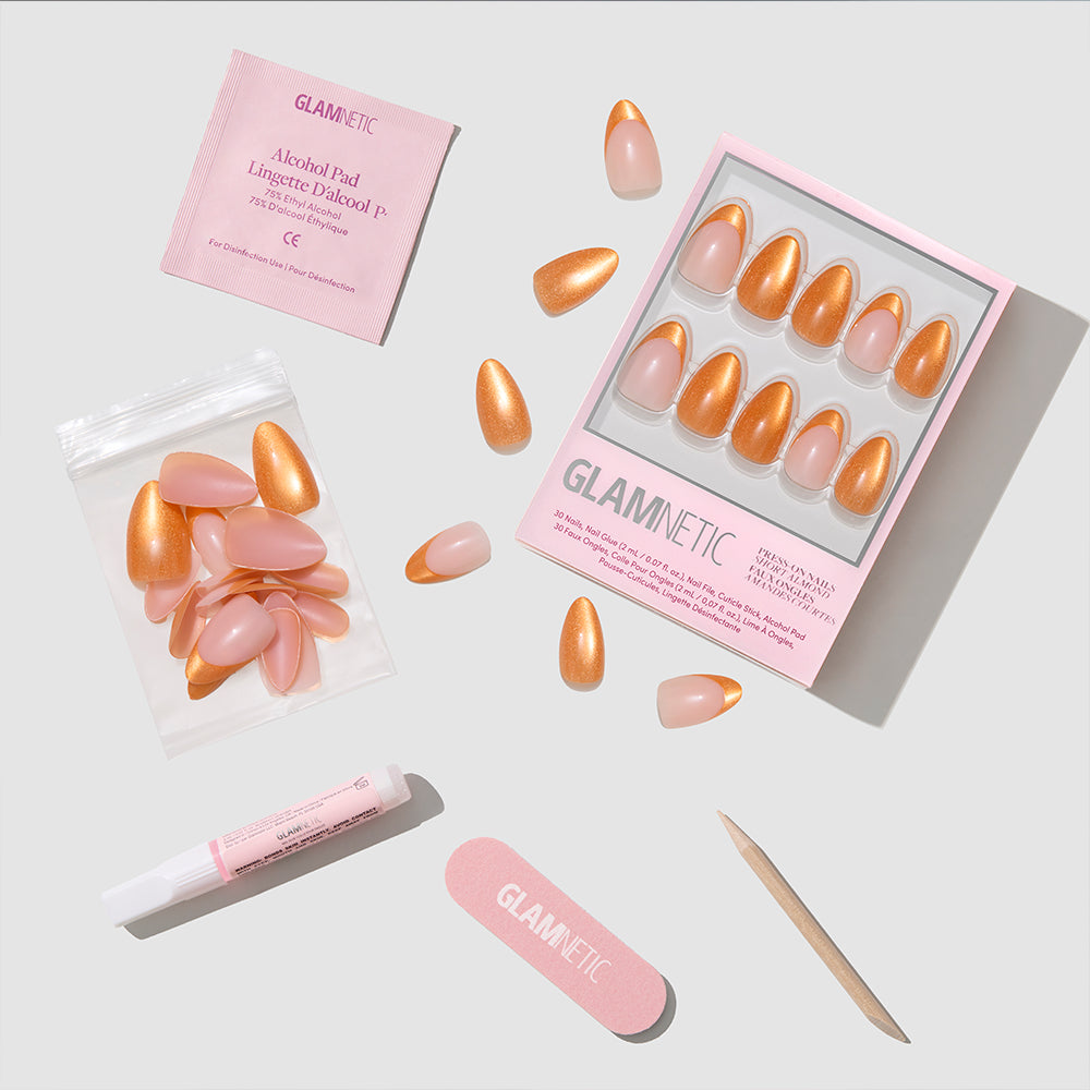 Glamnetic Orange Pop Press-On Nails feature short almond nails in peach and gold, shown with a nail file, cuticle stick, glue tube, alcohol pad, and extra nails against a light background. - Product image