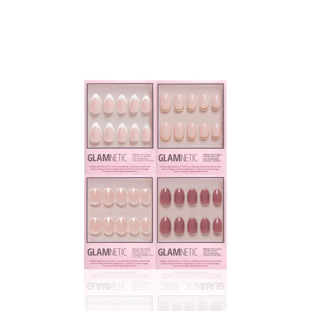 Four boxed sets of glamnetic Fall Classics press-on nails are shown, each set offering various pink and nude shades. Each pastel pink box displays product info and includes a bottle of nail glue at the bottom. - Product image
