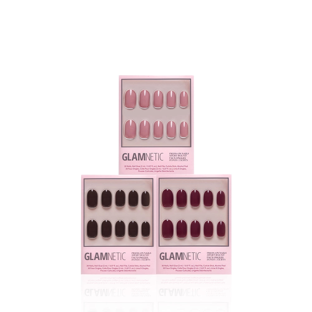 Three sets of Glamnetic Fall for Short Rounds salon-quality press-on nails by glamnetic, in pink, mauve, and burgundy shades, are displayed in pink packaging against a white background and feature chic short round nails for an effortless manicure. - Product image