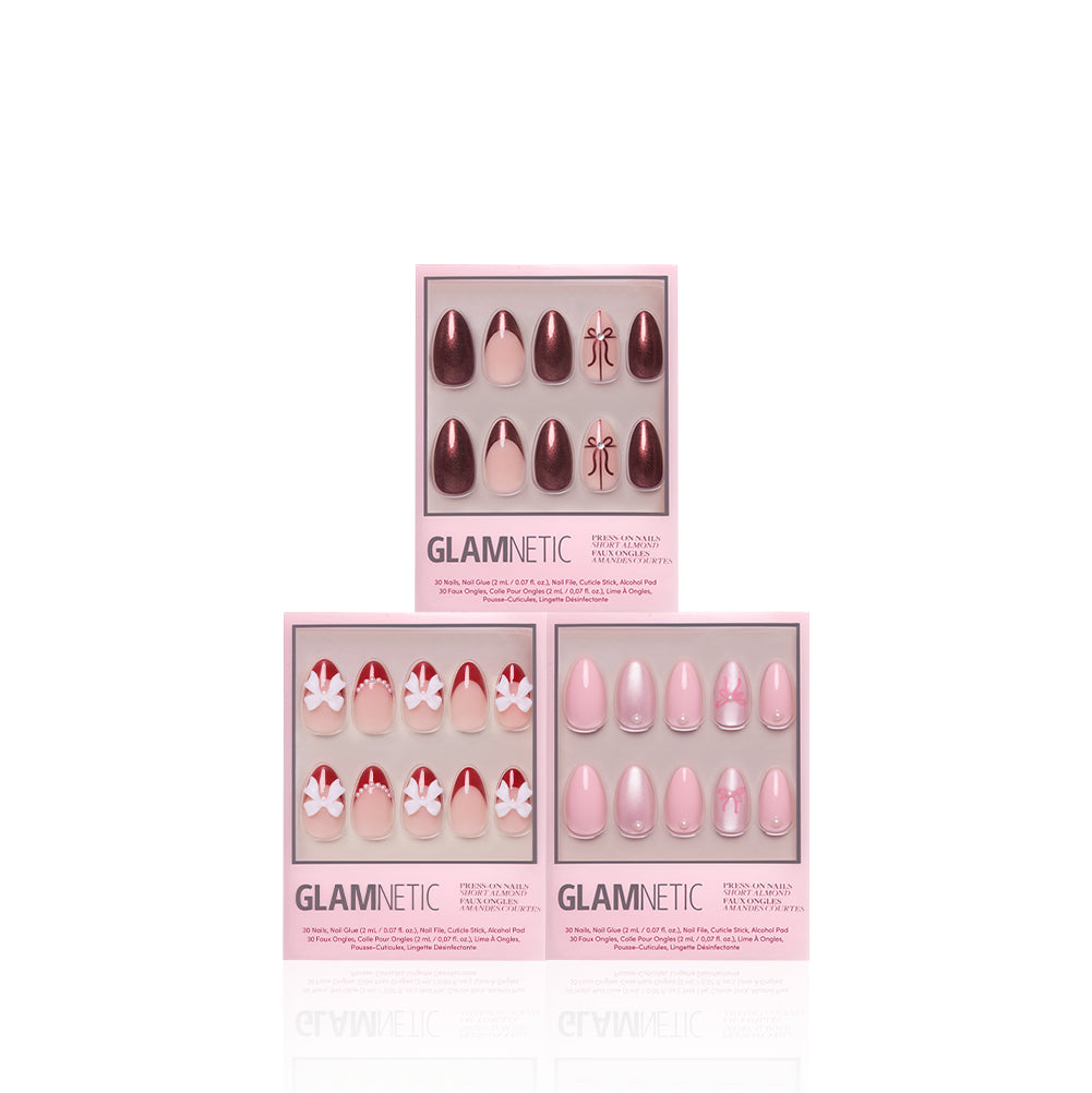 Three boxes of the glamnetic Fifth Ave Gift Display are shown in pink packaging. The press-on nails feature a variety of pink and burgundy designs—including solid hues, floral motifs, and geometric accents—displayed against a white background. This set is perfect for achieving salon-quality manicures at home or gifting as a holiday nail bundle. - Product image
