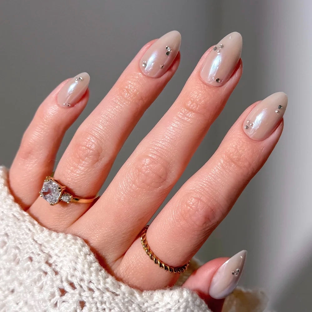Glamnetic First Dance glossy, pearlescent almond-shaped press-on nails featuring small 3D pearl stud accents on each nail.