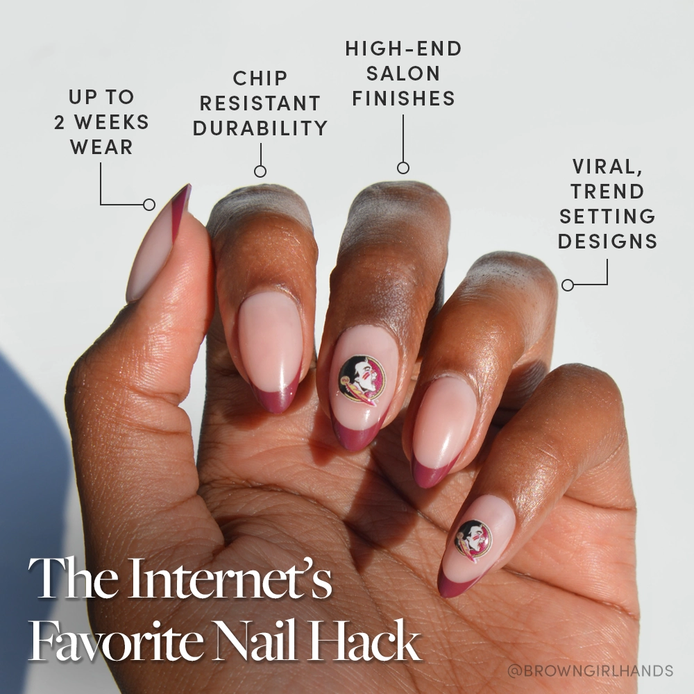A hand with almond-shaped, brown Florida State Seminoles Press-On Nails by glamnetic, featuring cartoon character decals on two fingers. Text highlights their long wear, chip resistance, salon-quality, and trendy garnet red French tips. - Product image