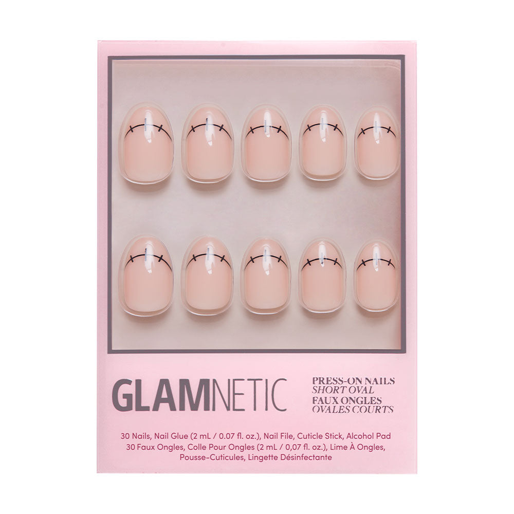 The glamnetic Frankenbabe press-on nails feature a short oval nude design with minimalist black eyelash tips, packaged in pink with product details below—perfect for a chic Halloween manicure.