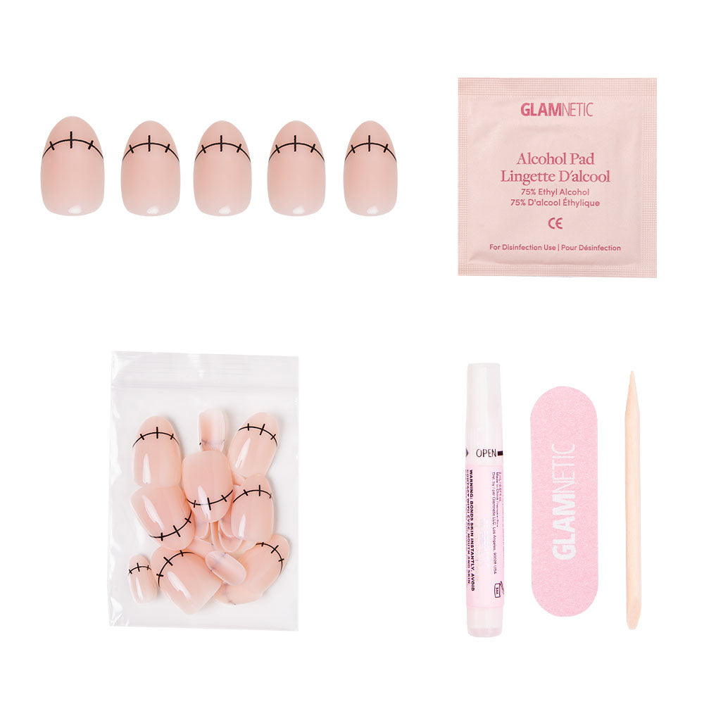 The Frankenbabe press-on nail kit by glamnetic features short oval nude nails with a stitched design, ideal for Halloween. Kit includes alcohol pad, pink nail file, cuticle stick, glue pen, and extra nails in a clear bag. - Product image