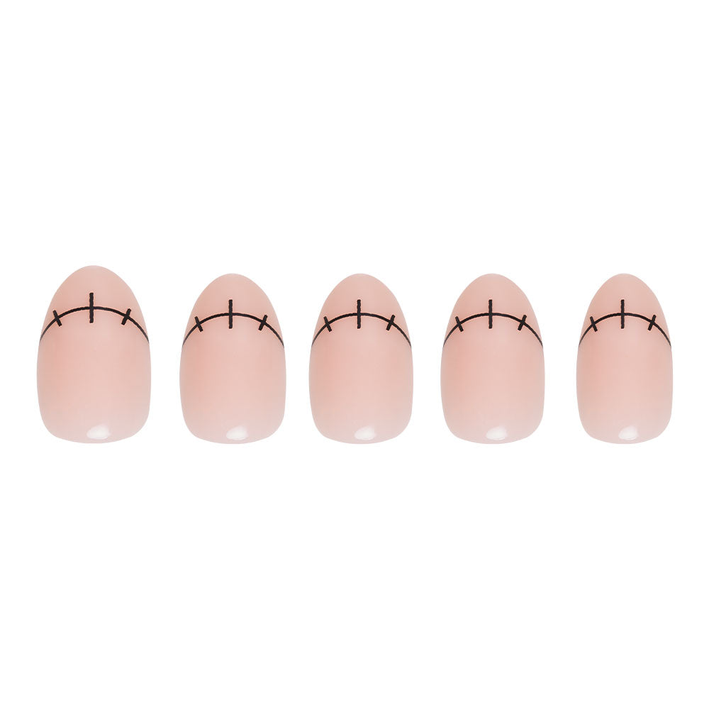Five artificial short oval nails from glamnetic’s Frankenbabe set feature a nude base with black curved lines and short vertical accents at the tips, creating a stitched look perfect for Halloween. - Product image