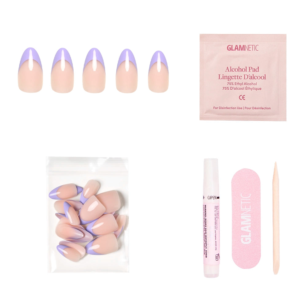 The glamnetic French Lilac Press-On Nails set features short almond nails with pastel purple tips, an alcohol pad, spare nails in a bag, nail glue pen, pink file, and cuticle stick—all displayed on a white background. - Product image