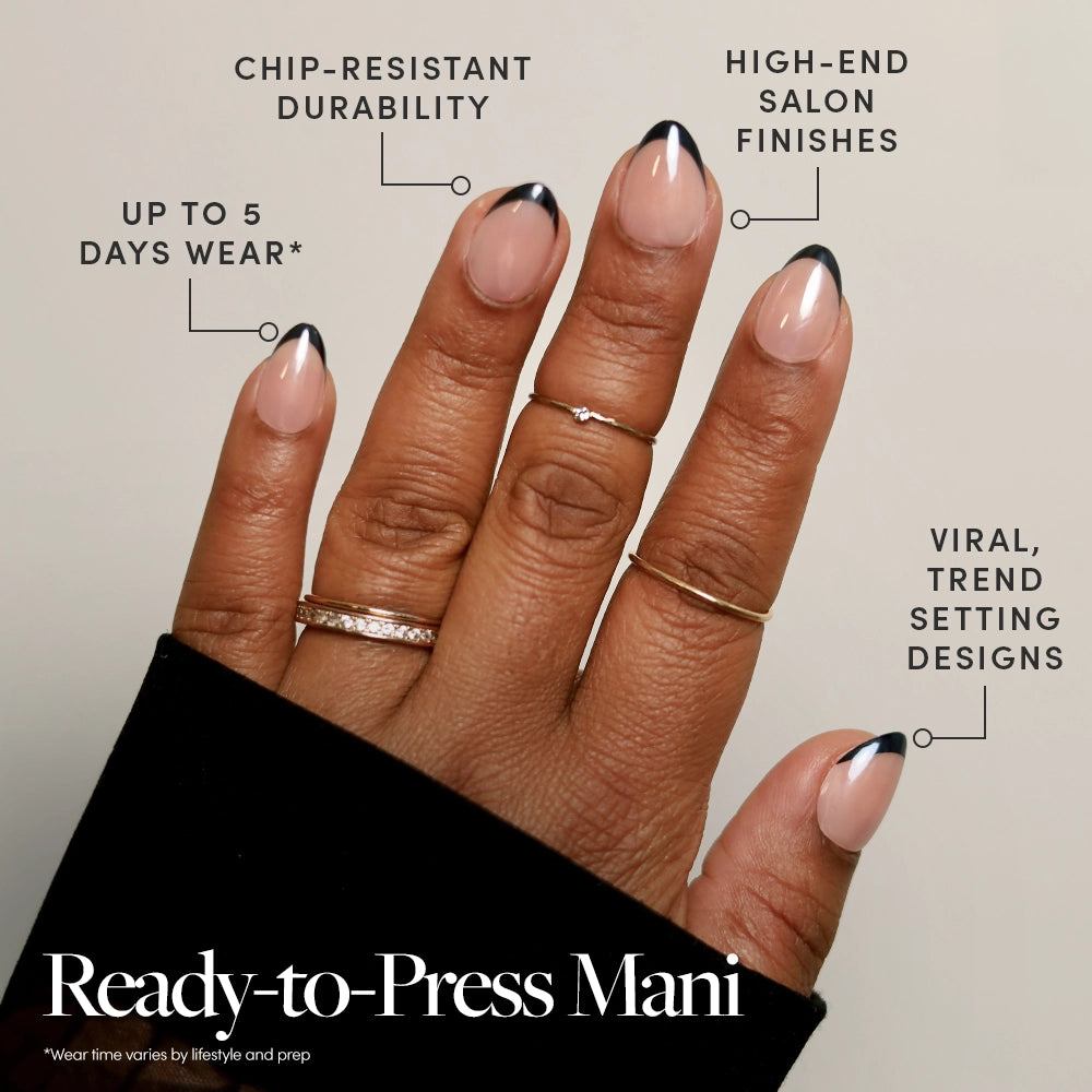 A hand with glamnetic French Noir medium almond press-on nails shows a nude base and black French tips, offering chip resistance, salon-quality finish, up to two weeks' wear, and trendy design. Text overlays highlight these features. - Product image