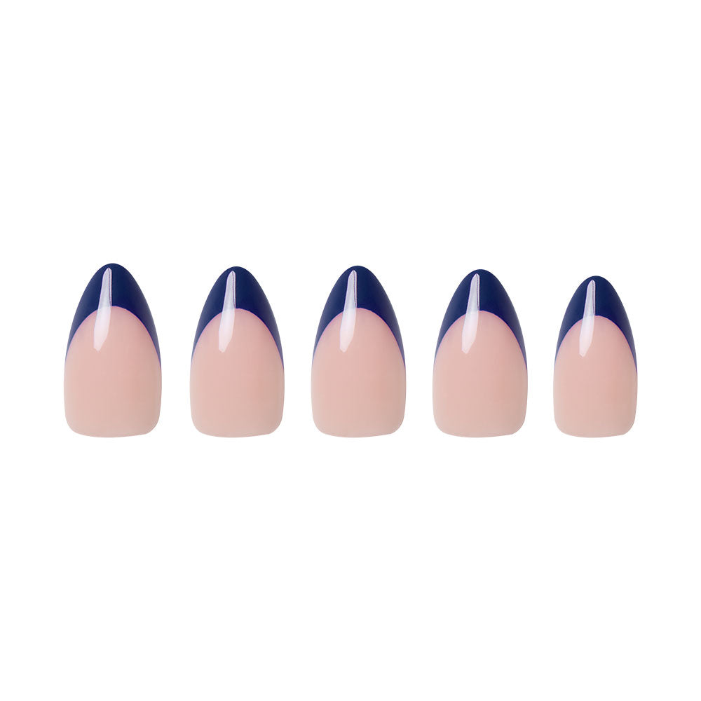 Five short almond nails from glamnetic’s French Riviera set showcase a nude base with navy French tips, each accented by a thin vertical white stripe on the tip, all arranged neatly on a white background for an effortlessly chic look. - Product image