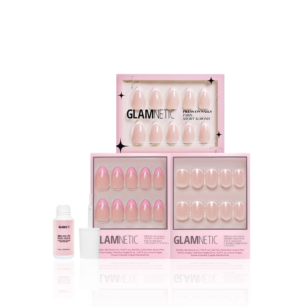 Three pink boxes of glamnetic French Tip Faves press-on nails, each showing salon-quality nude and pink French tips through a clear window, are arranged with a nail glue bottle in front against a white background. - Product image