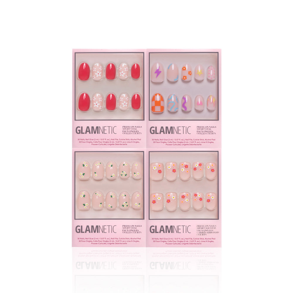 Four pink boxes of glamnetic Fresh Florals press-on nails, featuring designs like red with white flowers, pastel lightning bolts, orange checkerboard, and florals, are displayed on a white background. - Product image