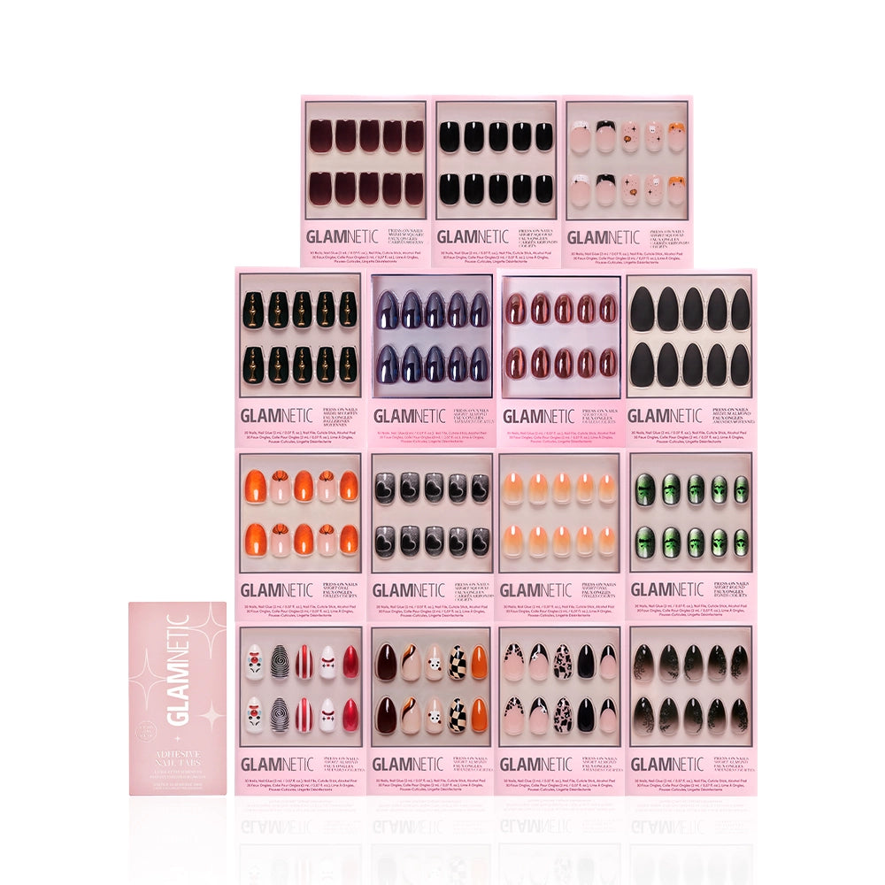 A display of 20 glamnetic Fright Night Collection press-on nails arranged in four rows, with a pink glamnetic instruction booklet in the bottom left corner for a hint of haunted glamour. - Product image
