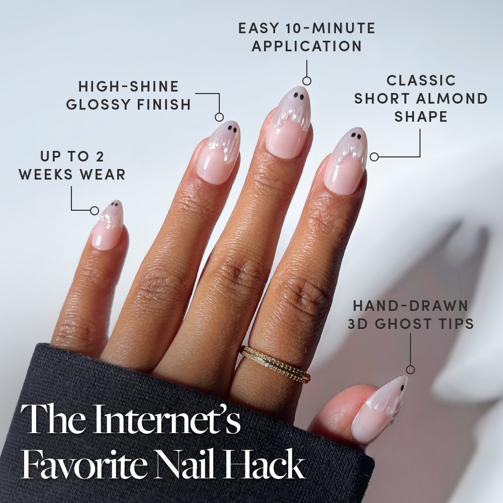 A hand with short almond-shaped nails showcases glamnetic’s Ghost Besties press-ons, featuring a glossy finish and hand-drawn 3D ghost nail art tips. Text highlights easy application, up to 2 weeks of wear, and “The Internet’s Favorite Nail Hack” at the bottom—perfect for those who love effortless press-on nails. - Product image