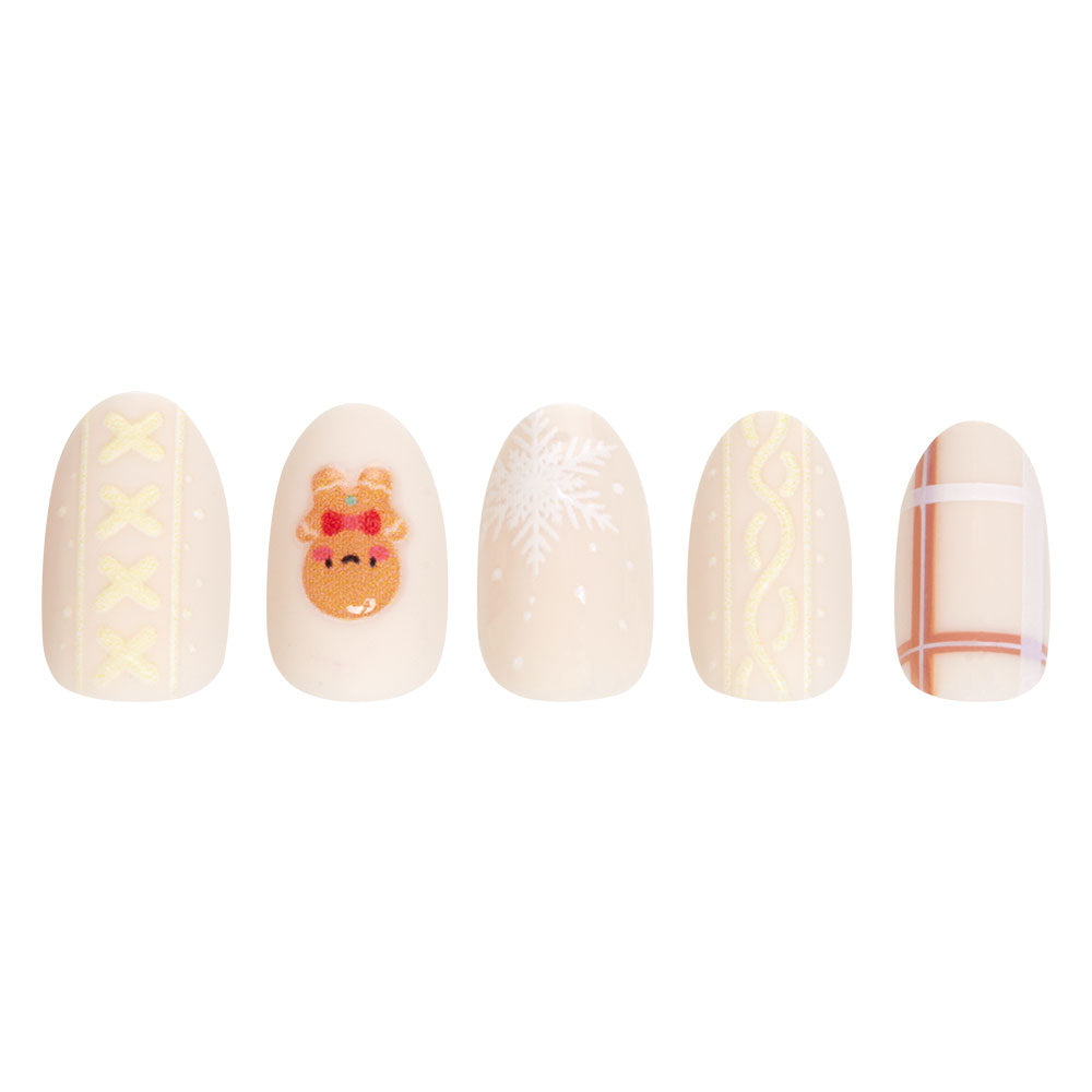 The Gingerbread Knit set by glamnetic features five festive artificial nails: yellow stitches, a reindeer face, a white snowflake, yellow squiggles, and a beige plaid pattern on pale cream—perfect for the holidays. - Product image