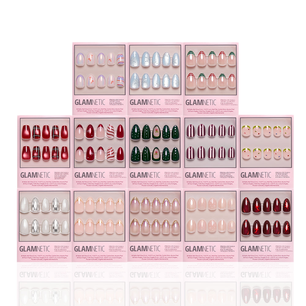 Twelve boxes of glamnetic’s Glam In The City Collection premium nail sets, featuring an array of holiday designs such as candy cane stripes, Christmas trees, snowflakes, and a festive palette of red, green, silver, and nude colors—all arranged in a three-row display for achieving salon-quality manicures at home. - Product image