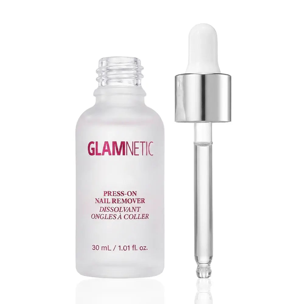 A clear bottle labeled glamnetic Press-On Nail Remover stands beside a dropper with a silver cap. The gentle remover comes in a 30 ml (1.01 fl. oz.) size, both displayed against a white background.