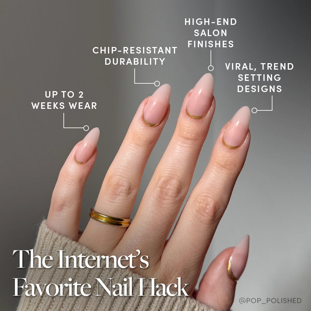 A hand with medium almond nails in glamnetic’s Goal Getter style features a soft pink manicure and gold French tips, offering chip resistance, salon finish, trendy design, and up to 2 weeks’ wear. Text: The Internet’s Favorite Nail Hack. - Product image
