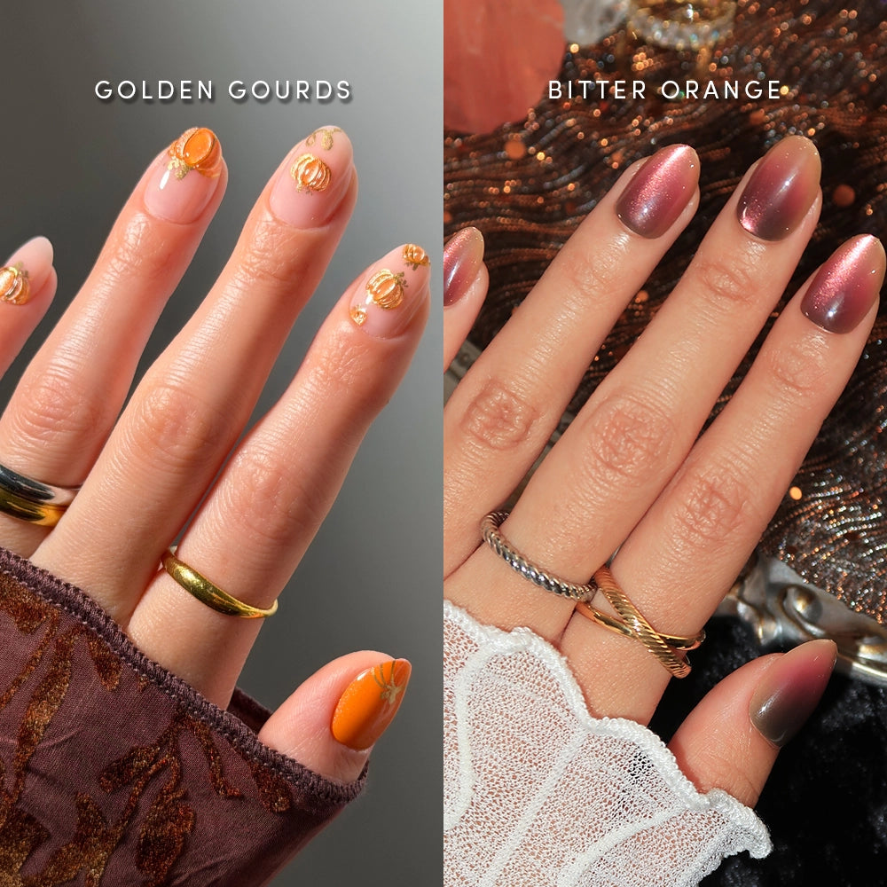 Two hands with manicured nails: the left features salon-quality short oval press-ons by glamnetic in “Gourd Intentions,” showcasing orange nail art with gold pumpkin designs; the right displays gradient pumpkin press-on nails that fade from pink to rich orange. Both hands are accessorized with several rings and decorative sleeves.