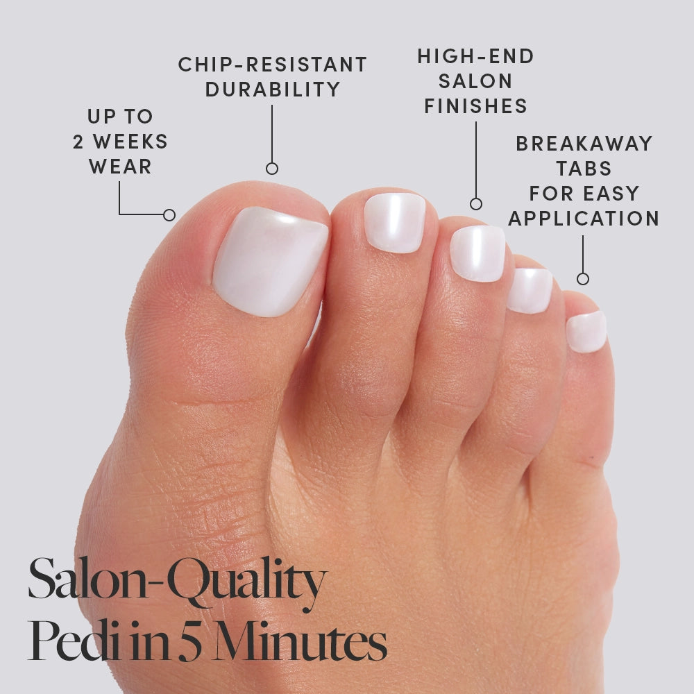 A foot wearing pearly white Glamnetic press-on toenails with product features called out, including salon finish and 2-week wear. - Product image