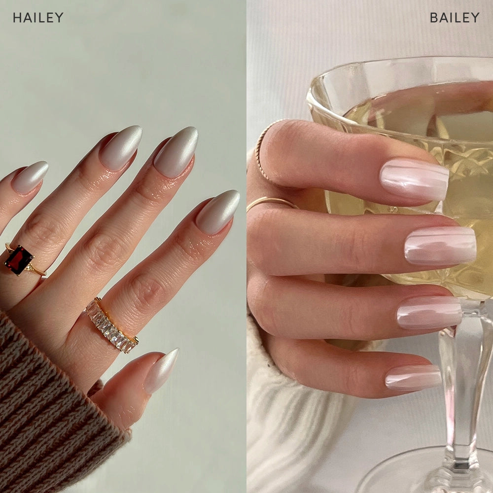 A split image features two hands with manicured nails using glamnetic's Bailey + Hailey: the left, "HAILEY," has short metallic silver-white almond nails and gold rings; the right, "BAILEY," shows glossy pale pink nails holding a glass.