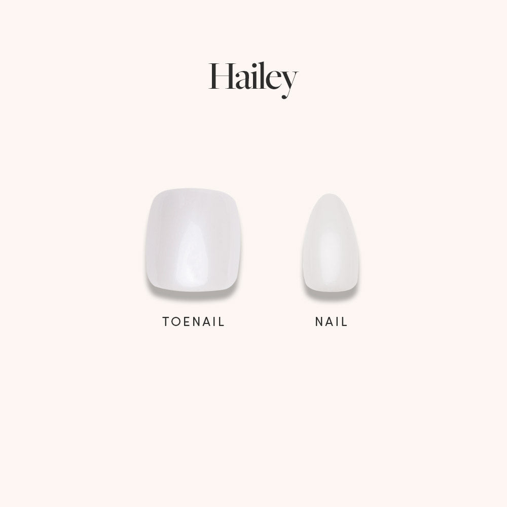 A comparison of two glamnetic Hailey Mani Pedi artificial nails on a light background, both with a pearly white glazed finish. The wider, square nail is for toes; the narrower, oval nail is for fingers. Hailey appears above them.