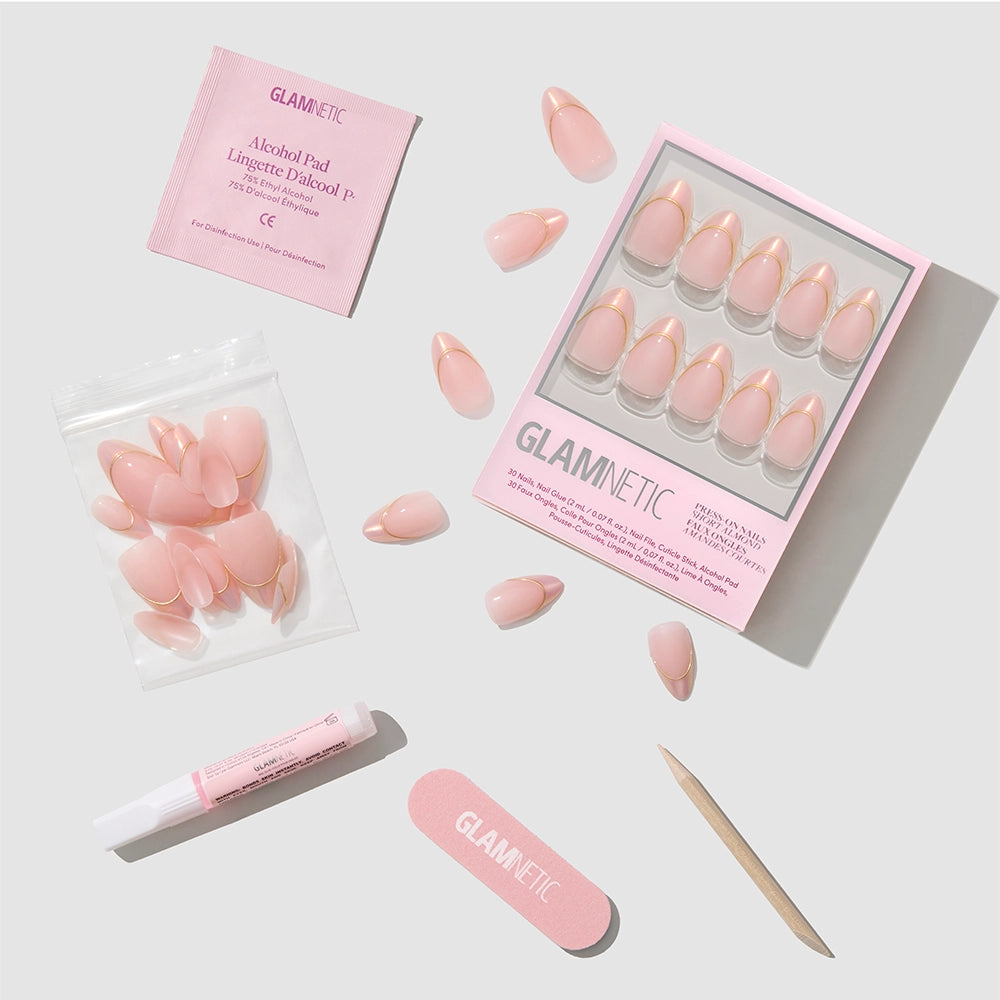 A set of Glamnetic Heavenly Touch pink press-on nails with elegant chrome French tips, including an alcohol pad, nail glue, extra nails, a nail file, and a wooden cuticle stick, all arranged neatly on a white background. - Product image