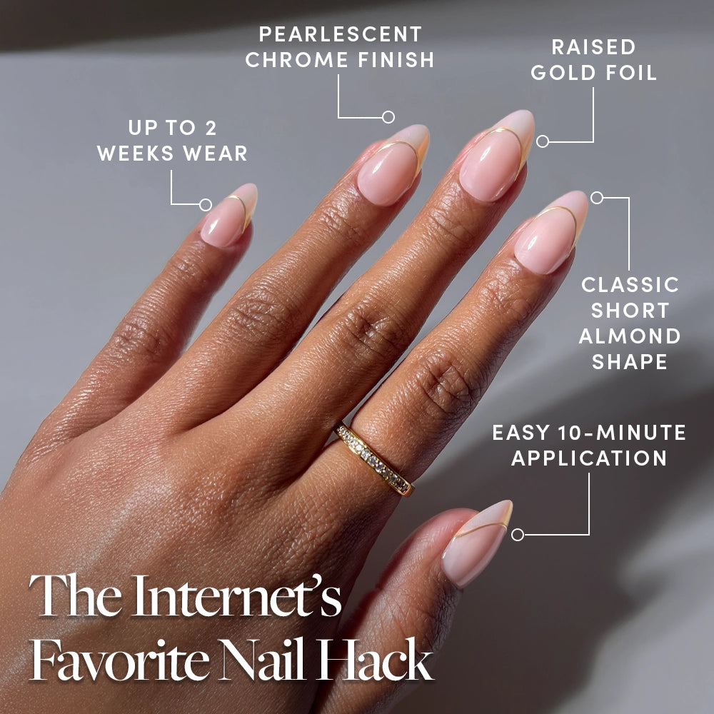 A hand wears glamnetic’s Heavenly Touch short almond press-on nails, showcasing a pearlescent base with lustrous chrome French tips and elegant gold foil accents. The text highlights 2-week wear, a 10-minute application, and a radiant chrome finish. The hand is adorned with a gold ring. - Product image