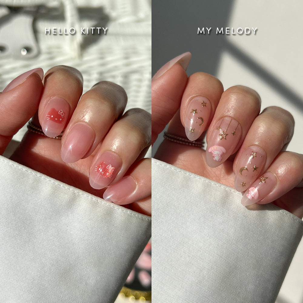 Two hands wearing Glamnetic Hello Kitty® Besties press-on nails: one hand features Hello Kitty and the other features My Melody designs with star and moon accents.