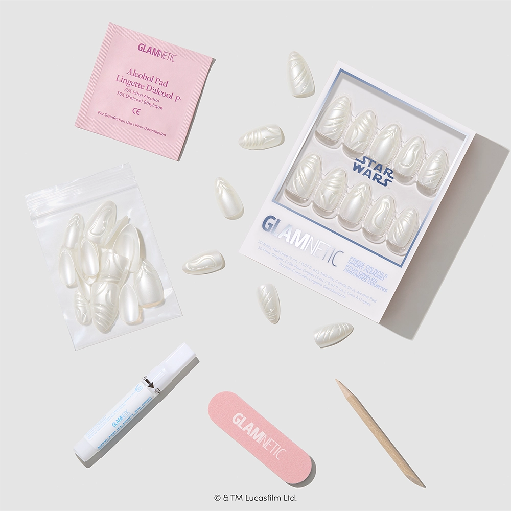 Help Me, Obi-Wan - Help Me, Obi-Wan press-on nails by glamnetic, featuring a short almond shape with a pearlescent chrome glaze, are arranged neatly on a light-colored surface along with an alcohol pad, nail file, cuticle stick, glue, and packaging labeled Star Wars and glamnetic.