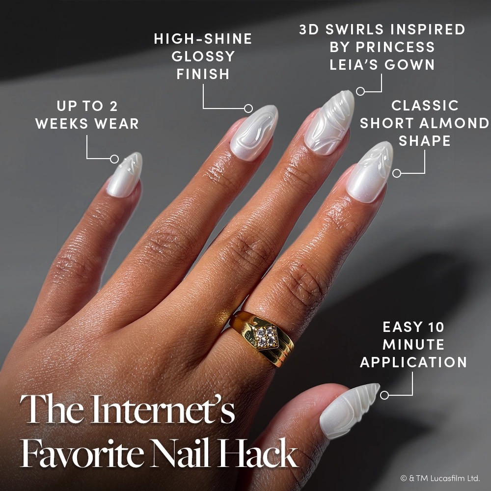 Help Me, Obi-Wan - A hand with short almond nails—the Help Me, Obi-Wan press-ons from glamnetic—shows off a pearlescent chrome glaze and glossy white shine with intricate 3D swirls, held up against a dark background. Text highlights the nails’ radiant finish, almond shape, mesmerizing swirls, quick application—just like your favorite glamnetic STAR WARS press-on nails—and their long-lasting wear.