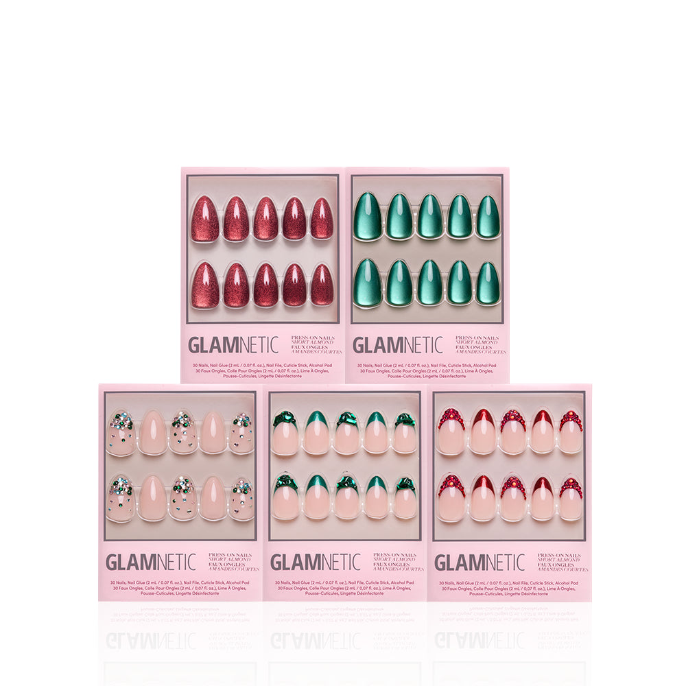 The Holiday Jewel Box - The Holiday Jewel Box by glamnetic features five boxes of 3D press-on nails in various designs, including metallic red, metallic green, and French tips with holiday-themed charms.