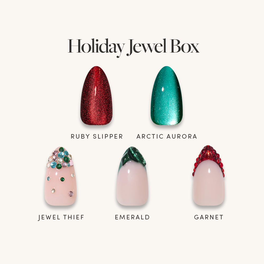 The Holiday Jewel Box by Glamnetic featuring five jewel tone press-on nail designs: Ruby Slipper, Arctic Aurora, Jewel Thief, Emerald, and Garnet.