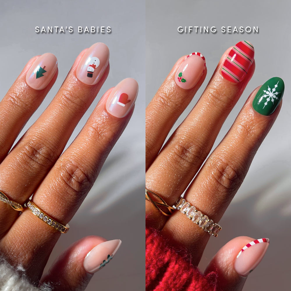 Two hands displaying Holly Jolly Short Ovals press-on nails featuring various festive designs, including Christmas trees, snowmen, mittens, candy cane stripes, holly berries, and snowflakes.