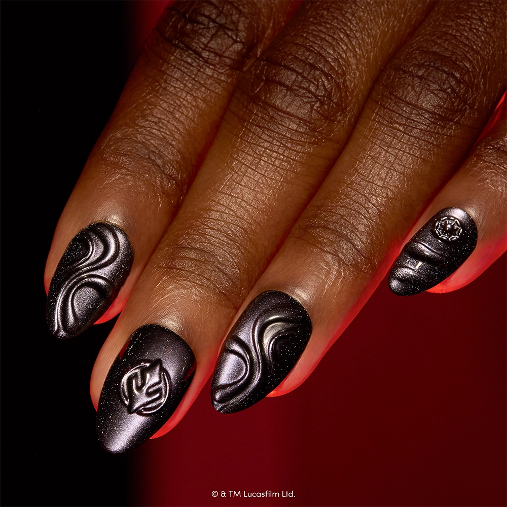 I Am Your Father - A hand with long, almond-shaped nails painted in glossy black is adorned with glamnetic’s “I Am Your Father” press-on nails, featuring eye-catching Darth Vader 3D designs on each finger, set against a deep red background.