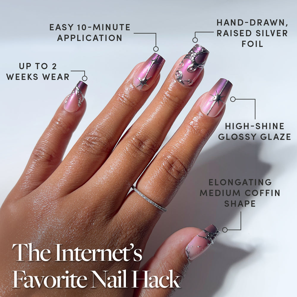 A hand showcases glamnetic’s Immortal Kiss coffin-shaped press-on nails in shiny pink, adorned with silver foil designs and rhinestones. The text highlights a quick 10-minute application, up to 2 weeks of wear, a glossy salon-quality finish, and stunning raised silver accents—ideal for anyone seeking a stylish and convenient coffin nail set. - Product image