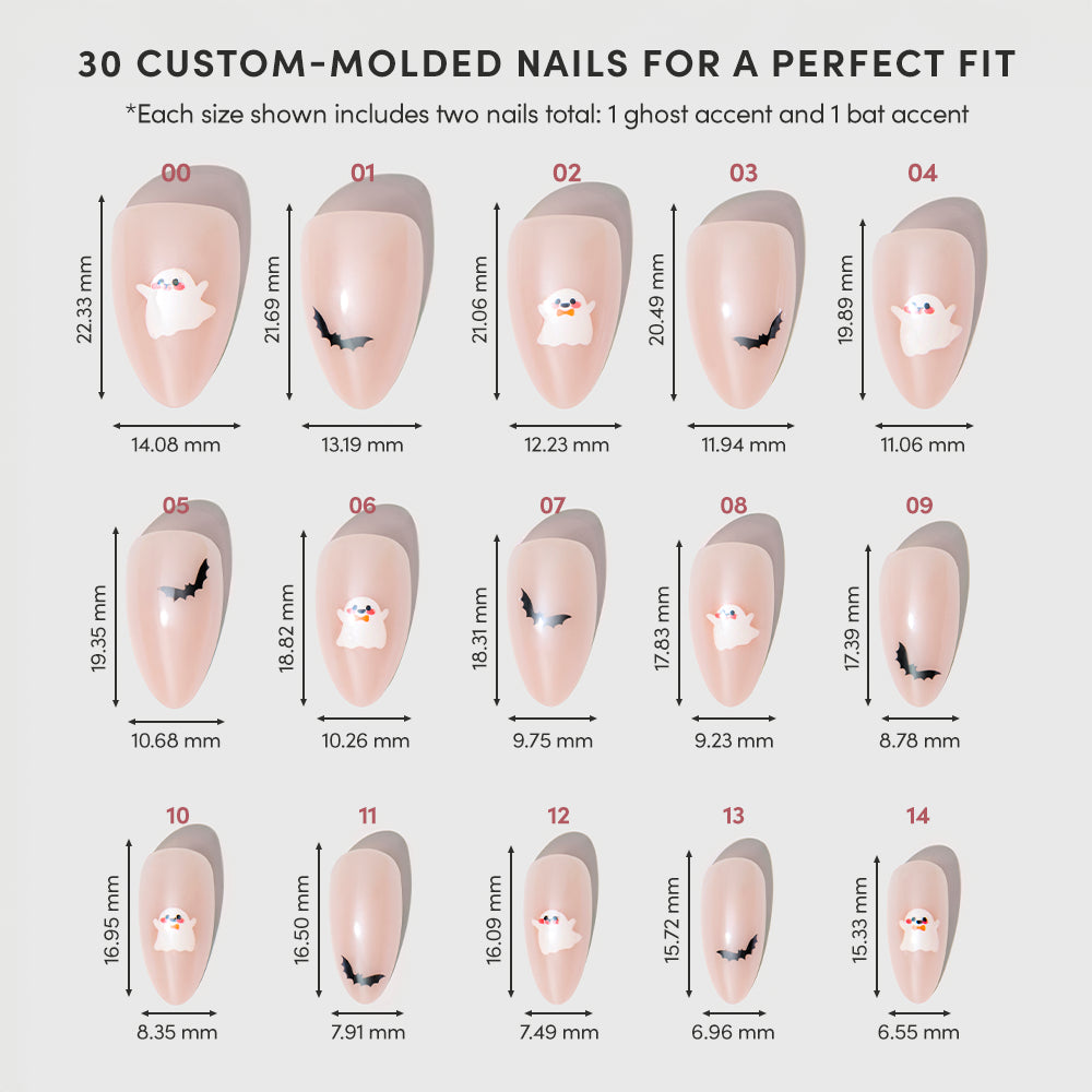 Sizing chart for the “In The Spirit” custom-molded press-on nails by glamnetic. The image displays 15 short almond nails labeled 00-14, featuring ghost and bat designs on a light pink base with a chic glazed finish. Each nail includes precise height and width measurements in millimeters. - Product image