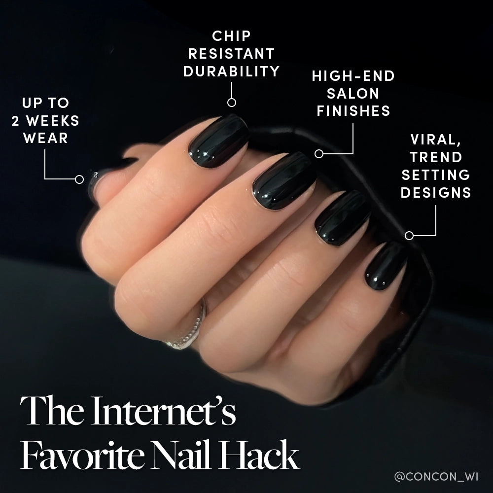 A hand with glossy black, perfectly polished nails holds a black sleeve. Featuring the glamnetic Jet Black: up to 2 weeks wear, chip-resistant durability, high-end finishes, and viral, trendsetting designs. - Product image