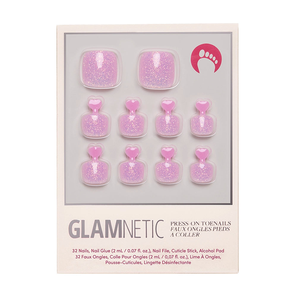 The glamnetic Juicy Toenail set includes 10 pink glitter, heart-topped vegan press-on toenails. This cruelty-free kit comes with nail glue and care accessories for easy application.