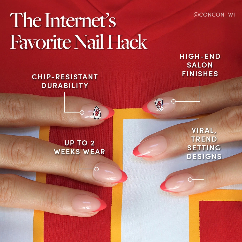 Close-up of hands with pink and red French tip nails featuring small graphic stickers. The glamnetic Kansas City Chiefs Press-On Nail Set offers salon-quality, trendy designs and up to 2 weeks of wear—a perfect nail hack for standout style. - Product image